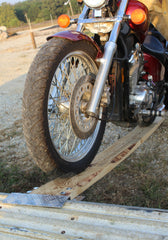 SINGLE DIAMOND PLATE ALUMINUM LOADING RAMP END KIT being used on the back of the truck, loading a motorcycle
